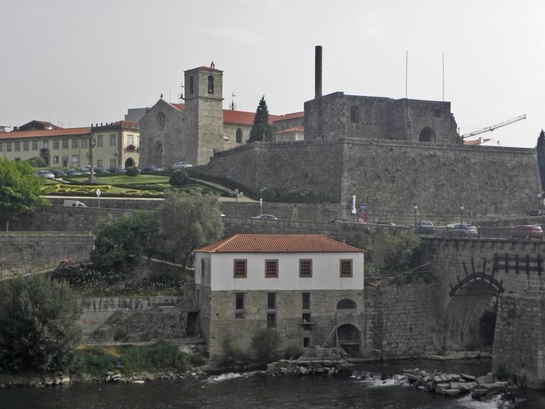 The church and the walls of old Barcelos on the banks of the Cávado