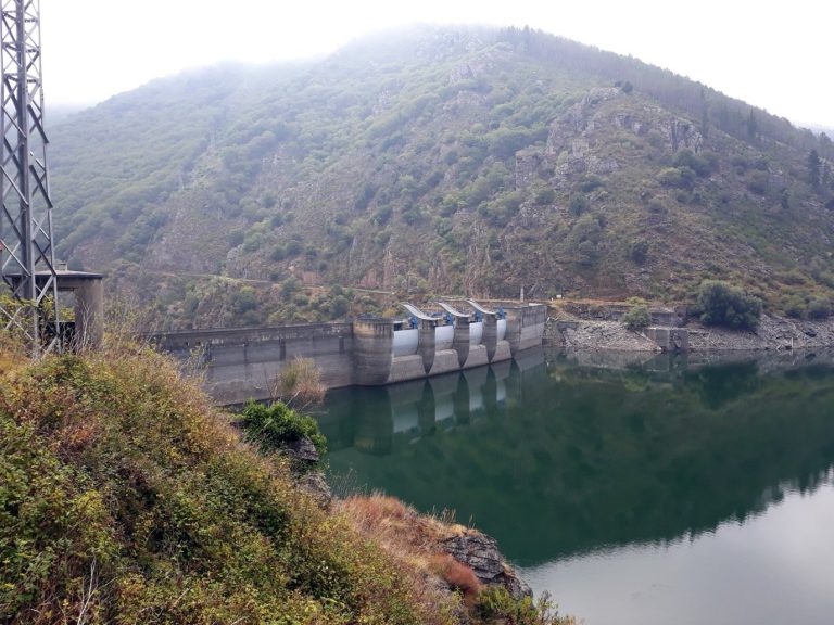 The Grandas de Salime dam and its reservoir between wooded slopes