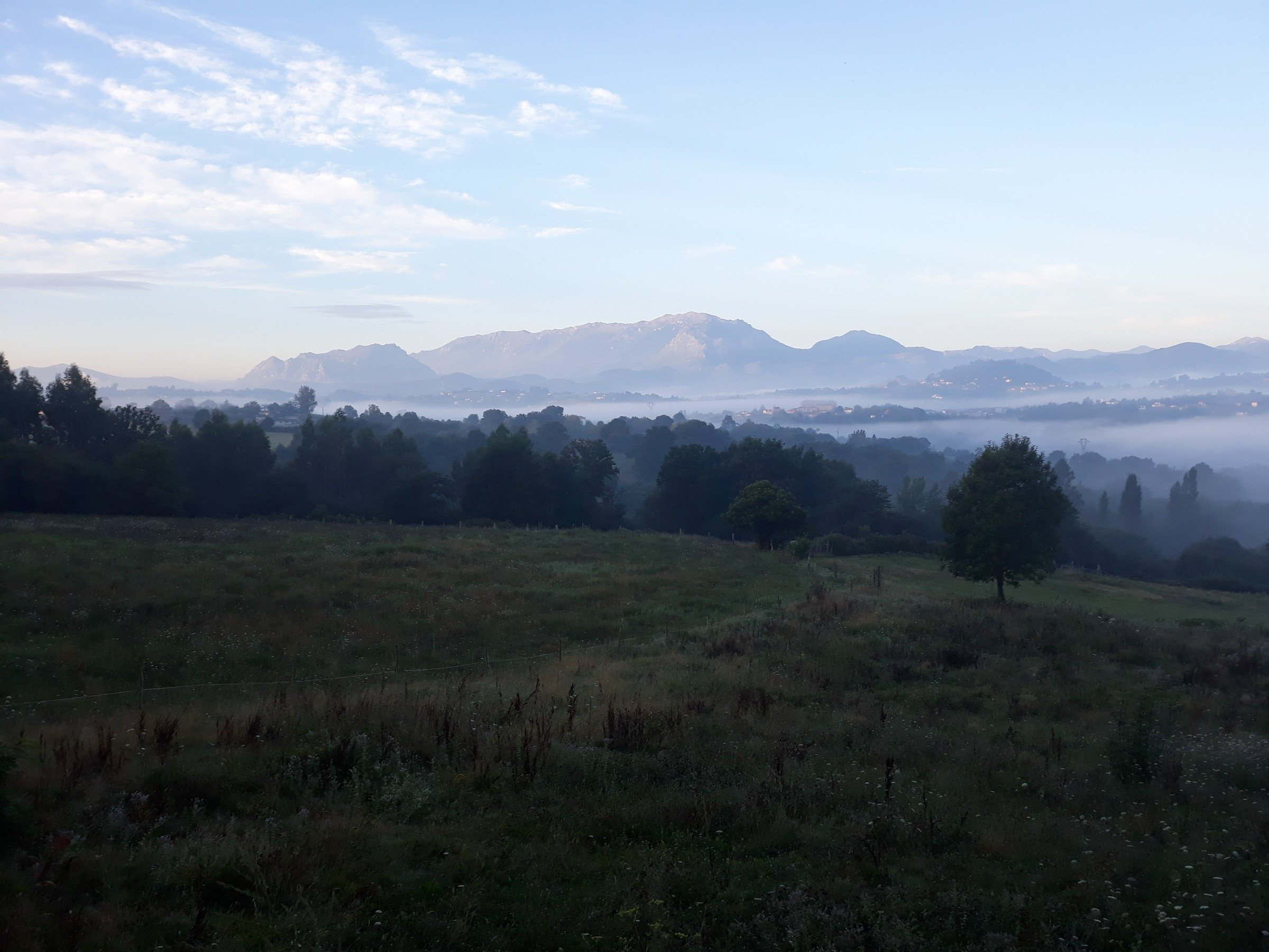 Misty dawn over the mountains of the Camino Primitivo near Llampaxuga, Asturias