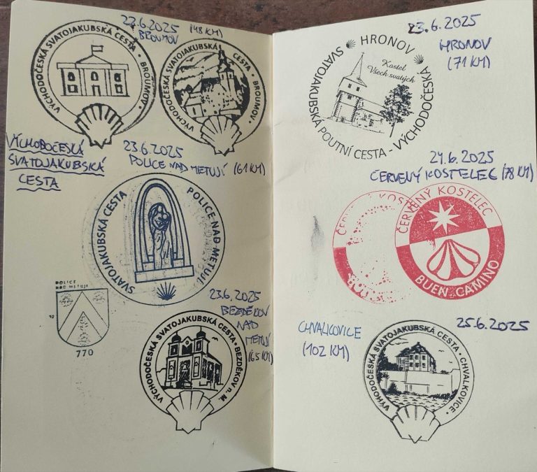 An open credencial (pilgrim passport) covered in stamps from the Czech Way of St James