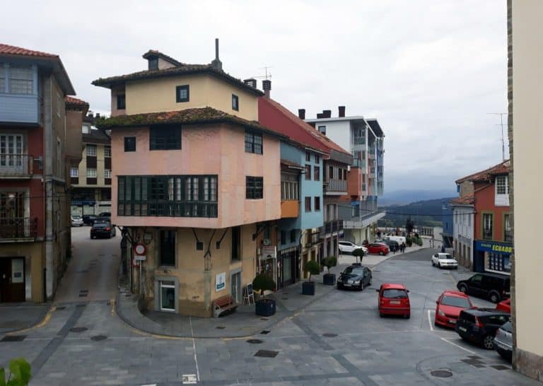 The centre of Tineo, its houses with glazed galleries and the mountains beyond